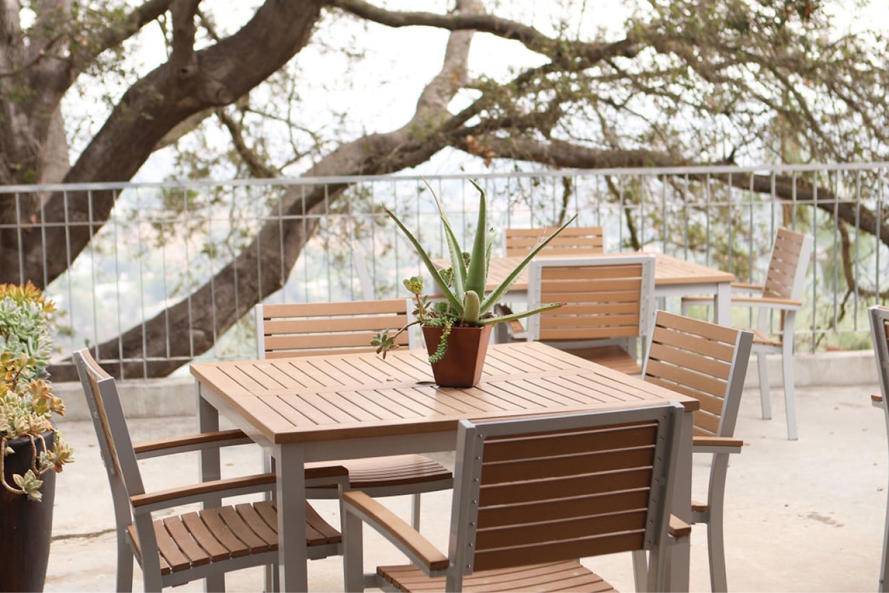 An outside table with empty seats overlooking the canyon