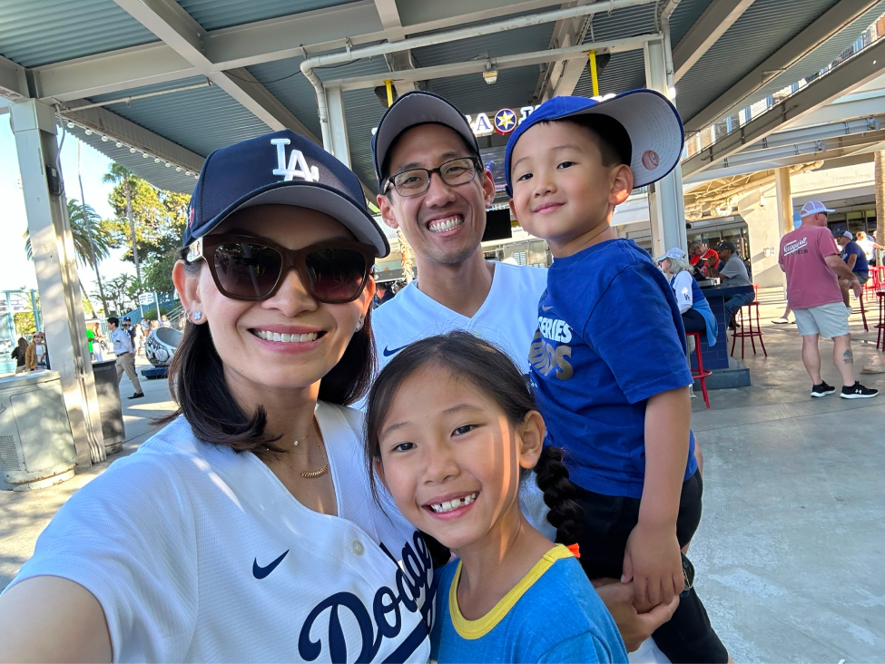 Family of four smiling in Los Angeles Dodgers gear