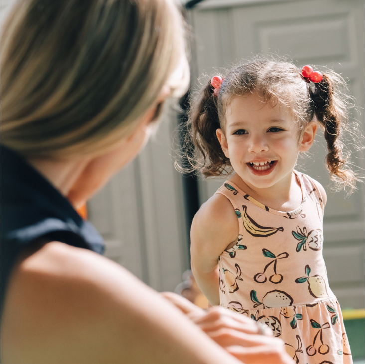 Child smiling at adult